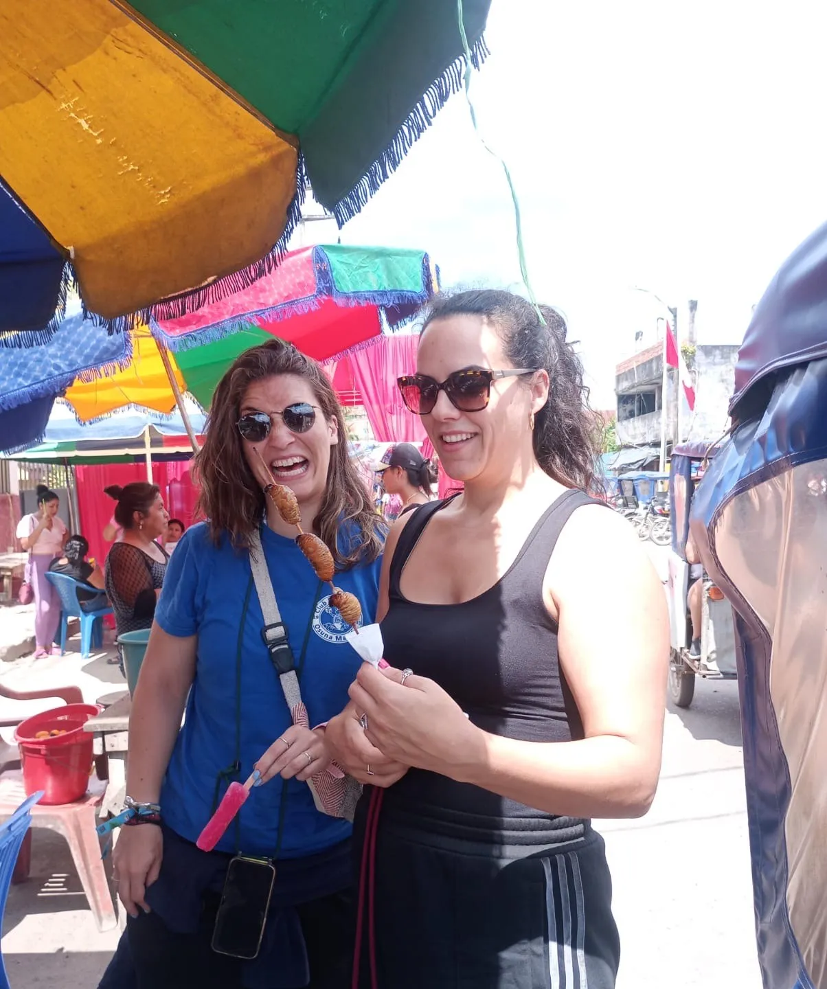 Guests trying exotic suri grub street food at a market in Iquitos