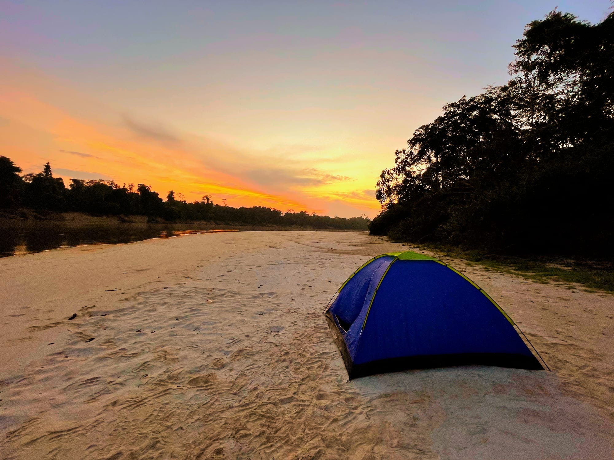 Tent on a sandy river beach at sunset on the Nanay River, Peruvian Amazon