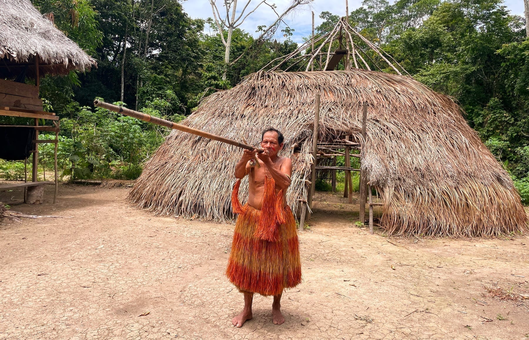 Yagua tribe member demonstrating a traditional blowgun