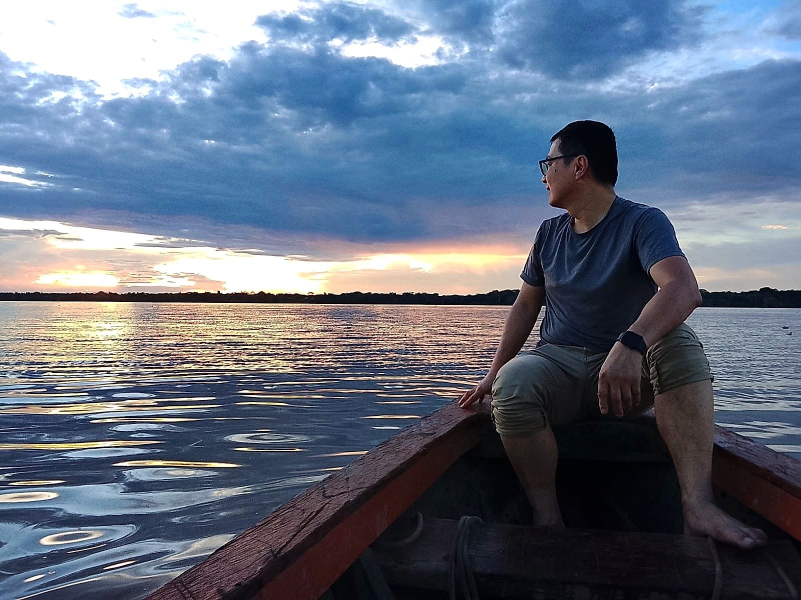 Guest watching the sunset from a boat on the Amazon River near Iquitos