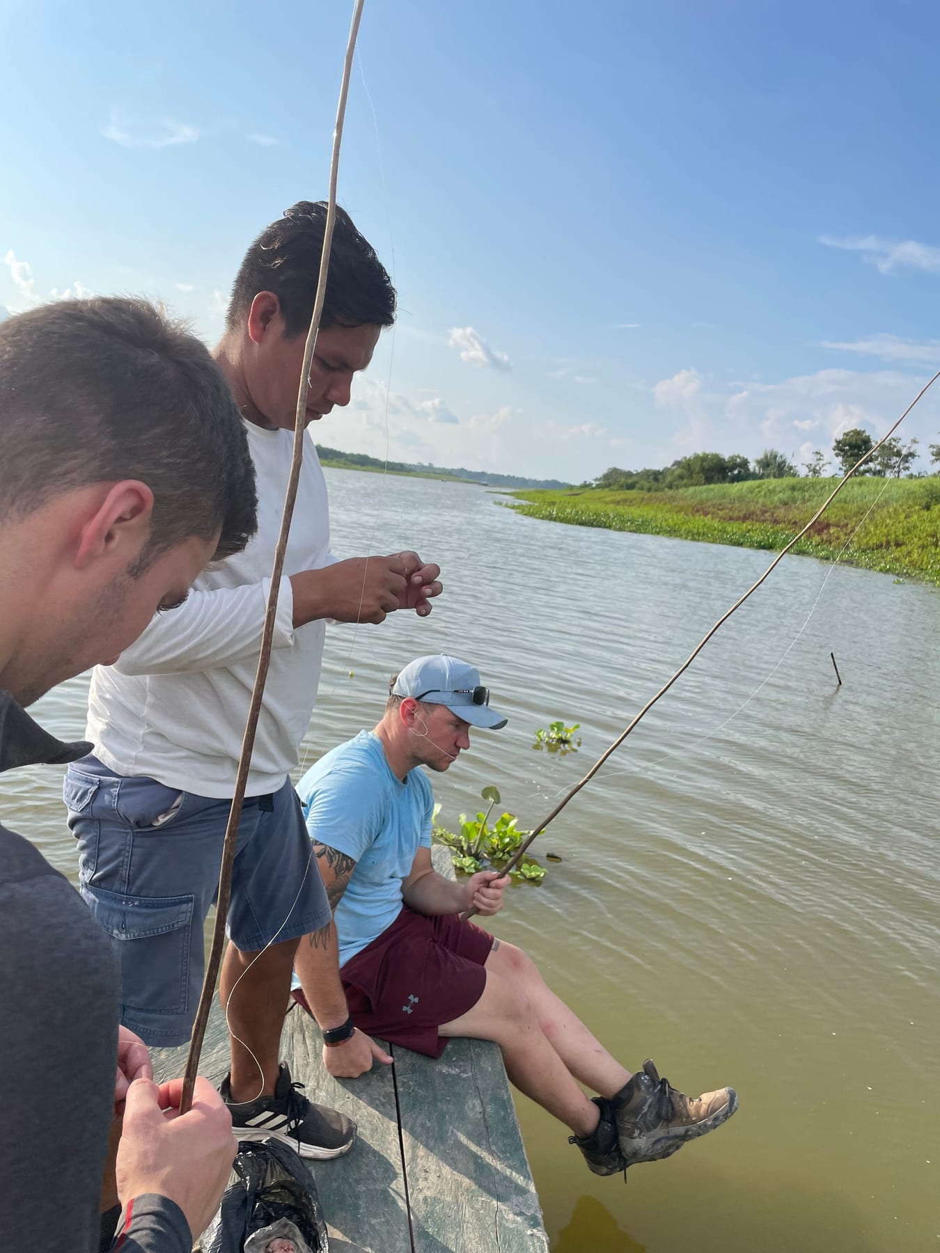 First-time angler sport fishing on the Amazon River with a Brisa guide