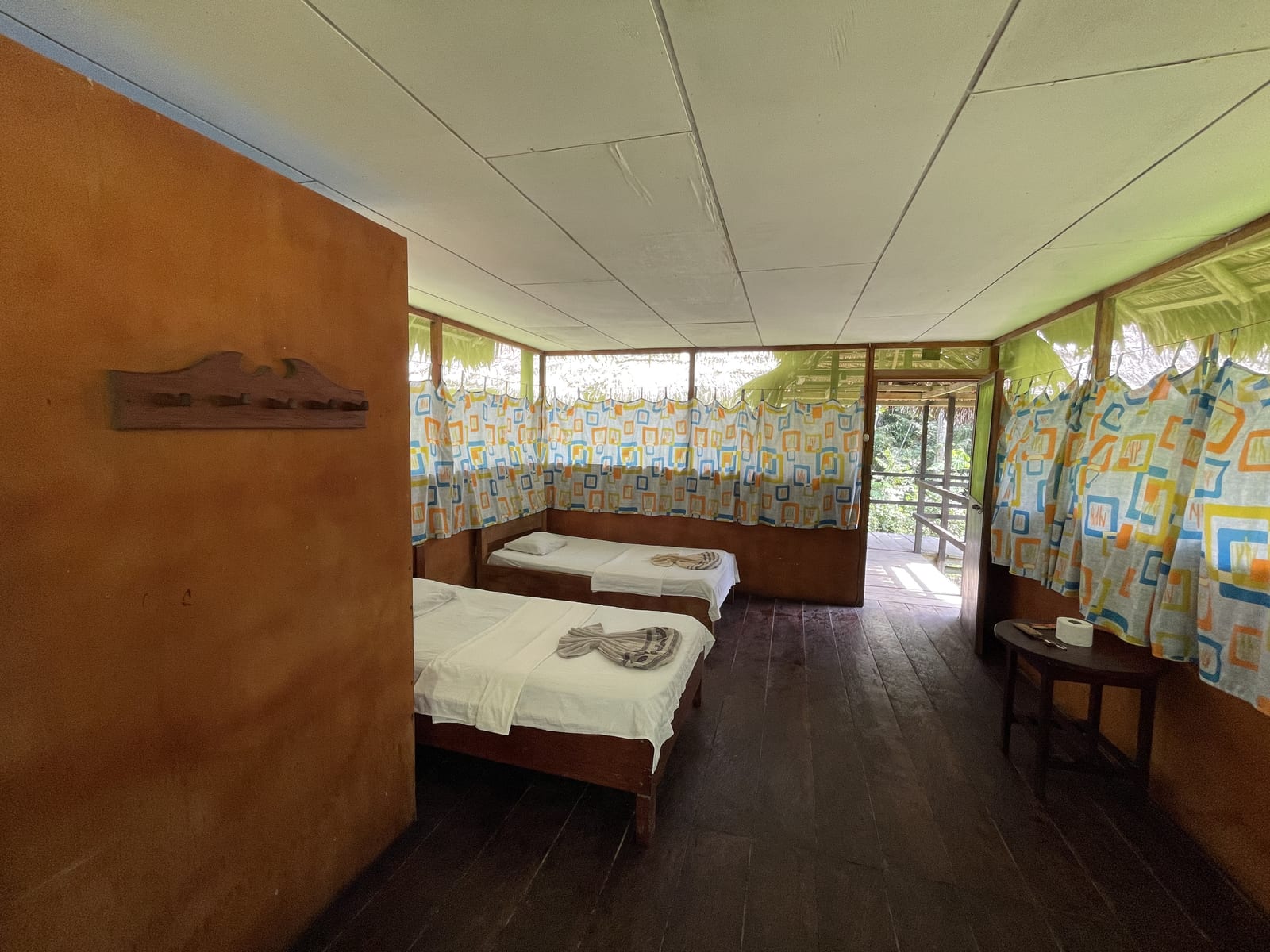Twin-bed room at the eco-lodge opening onto a jungle deck